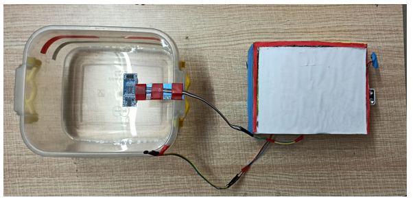 Ultrasonic sensor on the top of the container.
